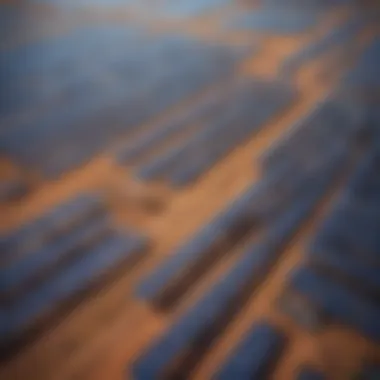 Aerial view of a solar farm in Australia showcasing expansive solar panels under a clear blue sky.